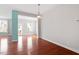Empty room with hardwood floors and large windows offering natural light at 2005 Ernesto Ln, Raleigh, NC 27603