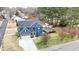 Aerial view of blue two-story home showcasing in-ground pool, deck, shed, and landscaped yard at 206 Hamby St, Clayton, NC 27520