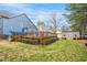 Backyard with a large wooden deck, storage shed and lush greenery, creating a private outdoor space at 206 Hamby St, Clayton, NC 27520