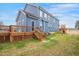 Backyard featuring a spacious wooden deck with stairs, a playset, and a grassy area, perfect for families at 206 Hamby St, Clayton, NC 27520