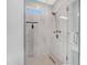 Walk-in shower features decorative tile work, light tile flooring, and a window at 206 Hamby St, Clayton, NC 27520
