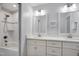 Bright bathroom featuring a shower-tub combo with white cabinets and double sink vanity at 206 Hamby St, Clayton, NC 27520