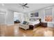 Spacious bedroom with hardwood floors, lots of light, ceiling fan, and a dark wood bed frame at 206 Hamby St, Clayton, NC 27520