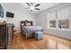 Bedroom with wood floors features a grey bed, ceiling fan, natural light and desk at 206 Hamby St, Clayton, NC 27520