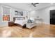 Spacious bedroom with hardwood floors, lots of light, ceiling fan, and a dark wood bed frame at 206 Hamby St, Clayton, NC 27520