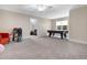 Spacious bonus room with an air hockey table, plush carpet, and neutral paint at 206 Hamby St, Clayton, NC 27520