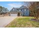 Two-story home featuring blue siding, stone accents, and well-maintained lawn, creating a welcoming curb appeal at 206 Hamby St, Clayton, NC 27520