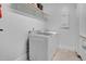 Clean laundry room with modern, front-loading washing and drying machines at 206 Hamby St, Clayton, NC 27520