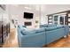 A living area with hardwood floors, a fireplace, a large blue sofa, and a sliding barn door at 206 Hamby St, Clayton, NC 27520