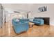 Spacious open living area with hardwood floors, a large L-shaped sectional sofa, and access to the kitchen at 206 Hamby St, Clayton, NC 27520
