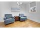 Sitting room featuring two blue chairs, hardwood floors, and a window at 206 Hamby St, Clayton, NC 27520