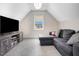 Attic living room area featuring an oversized sectional and media center at 206 Hamby St, Clayton, NC 27520