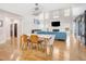 Open-concept dining and living area with high ceilings, hardwood floors, and modern decor at 206 Hamby St, Clayton, NC 27520
