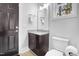 Modern powder room featuring a dark door and granite sink at 206 Hamby St, Clayton, NC 27520
