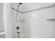 Modern shower with white tile, a decorative accent strip, and bronze hardware at 206 Hamby St, Clayton, NC 27520