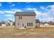 View of backyard with an in-ground irrigation system, a patio and a spacious lawn at 252 Olde Place Dr, Zebulon, NC 27597