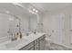 Bathroom featuring double vanity sinks, sleek cabinets, and a shower at 252 Olde Place Dr, Zebulon, NC 27597