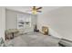 Bright bedroom with a ceiling fan, neutral walls, and a window overlooking the neighborhood at 252 Olde Place Dr, Zebulon, NC 27597
