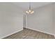 Neutral dining room with wood-look floors, chandelier lighting, and plenty of space for gatherings at 252 Olde Place Dr, Zebulon, NC 27597