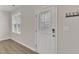 Clean entryway features a white door with decorative glass, wood-look floors, and a window at 252 Olde Place Dr, Zebulon, NC 27597