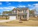 Lovely two-story home with a two-car garage and a well-kept lawn in a peaceful neighborhood at 252 Olde Place Dr, Zebulon, NC 27597