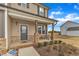 Inviting front porch with brick accents and a cozy seating area, perfect for relaxing outdoors at 252 Olde Place Dr, Zebulon, NC 27597