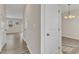 Bright hallway with wood-look flooring and neutral paint, leading to various rooms in the home at 252 Olde Place Dr, Zebulon, NC 27597