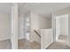 Upstairs hallway with access to multiple bedrooms and stairway at 252 Olde Place Dr, Zebulon, NC 27597