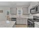 Kitchen featuring granite countertops, stainless steel appliances, a stylish backsplash, and ample natural light at 252 Olde Place Dr, Zebulon, NC 27597