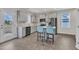 The kitchen offers gray cabinets, stainless appliances, and an island with counter seating and bright natural light at 252 Olde Place Dr, Zebulon, NC 27597