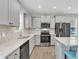 Bright kitchen boasts stainless steel appliances, granite countertops, and ample cabinet space at 252 Olde Place Dr, Zebulon, NC 27597