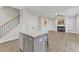 This kitchen island offers seating and connects to the living space, featuring a fireplace and built-in shelving at 252 Olde Place Dr, Zebulon, NC 27597