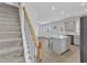 Open-concept kitchen with a granite island, adjacent to living area and stairway at 252 Olde Place Dr, Zebulon, NC 27597