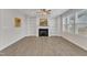 Bright living room with a fireplace flanked by built-in shelving and filled with natural light from large windows at 252 Olde Place Dr, Zebulon, NC 27597