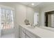 This bathroom features a long vanity with double sinks and a large mirror and windows at 2602 Vintage Hill Ct, Durham, NC 27712