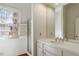 Bright bathroom featuring a window view, white cabinets, and a tub and shower at 2602 Vintage Hill Ct, Durham, NC 27712