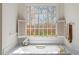 Bathroom features soaking tub with shutters and tile surround at 2602 Vintage Hill Ct, Durham, NC 27712