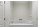 Cozy bathroom showcases a white tile soaking tub with chrome fixtures and white walls at 2602 Vintage Hill Ct, Durham, NC 27712