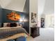 Stylish bedroom featuring dark blue accent wall, comfortable bed and carpeted floor at 2602 Vintage Hill Ct, Durham, NC 27712