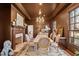 Elegant dining room featuring a fireplace, chandelier, and ample seating, ideal for entertaining guests at 2602 Vintage Hill Ct, Durham, NC 27712