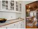Dining area features elegant glass cabinets and a view of the dining room with chandelier at 2602 Vintage Hill Ct, Durham, NC 27712
