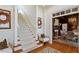Inviting entryway with staircase, hardwood floors, and view to dining room, creating a warm, welcoming ambiance at 2602 Vintage Hill Ct, Durham, NC 27712