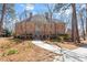 Stately brick home featuring a symmetrical design, mature trees, and well-manicured landscaping at 2602 Vintage Hill Ct, Durham, NC 27712