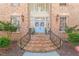 Close up of home's entrance with charming light blue doors, brick steps and wrought iron railings at 2602 Vintage Hill Ct, Durham, NC 27712