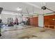 Large garage featuring overhead lighting, three garage door openings and ample storage space at 2602 Vintage Hill Ct, Durham, NC 27712