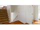 Hallway features hardwood floors, stairs and view to a bathroom at 2602 Vintage Hill Ct, Durham, NC 27712