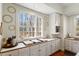 Sunlit kitchen boasts white cabinetry, wood countertops, stainless appliances, and decorative wall accents at 2602 Vintage Hill Ct, Durham, NC 27712