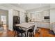 Bright kitchen features white cabinetry, stainless steel appliances, island with seating, and wood floors at 2602 Vintage Hill Ct, Durham, NC 27712