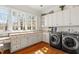 Bright laundry room featuring a desk space, storage cabinets, and a washer and dryer at 2602 Vintage Hill Ct, Durham, NC 27712