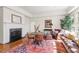 Cozy living area with hardwood floors, large windows, comfortable seating, and stylish decor at 2602 Vintage Hill Ct, Durham, NC 27712